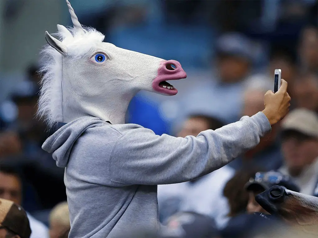 wersm-man-wearing-a-unicorn-mask-taking-a-selfie